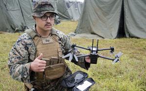 A Marine gives the all-clear for flight while demonstrating the Skydio X2D unmanned aircraft system.