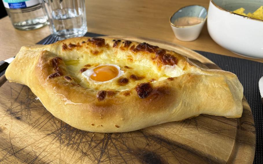 The Adjarian khachapuri at Kinto is one variation of Georgia's national dish. The leavened bread dough is formed into a boat, filled with cheese and butter, and topped with an egg yolk, which cooks when mixed with the cheese. 