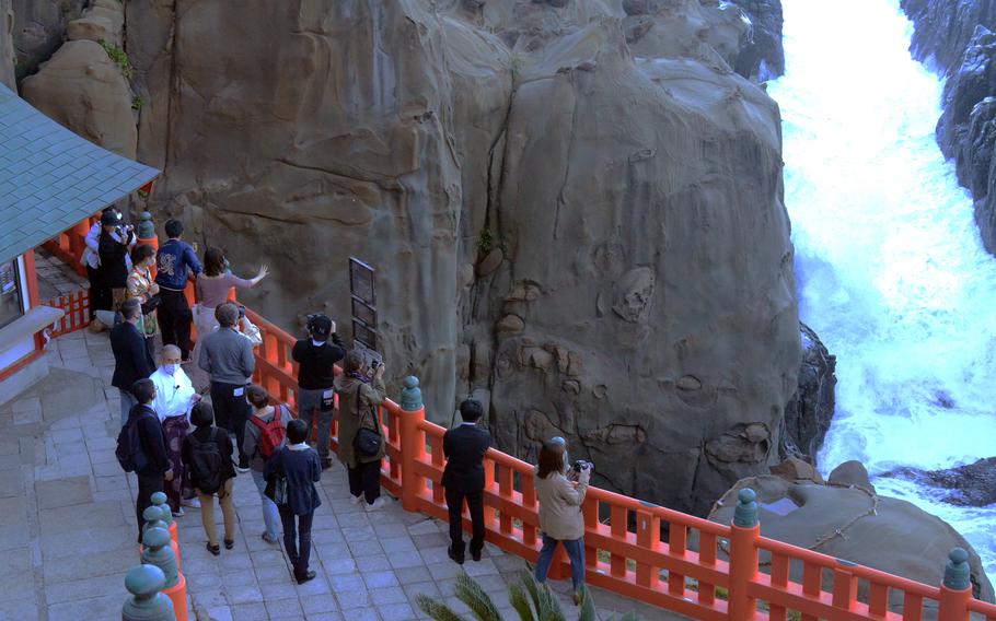 At Udo Shrine in Miyazaki prefecture, Japan, visitors can purchase clay balls and attempt to toss them into a rope circle on top of a rock below.