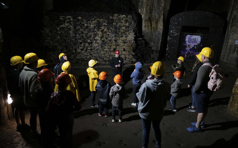 A tour guide points out a filming location used in several German movie productions, including "Vampire Sisters 3," on Sept. 21, 2024, in Mendig, Germany. The atmospheric basalt caverns have become popular shooting sites for filmmakers.