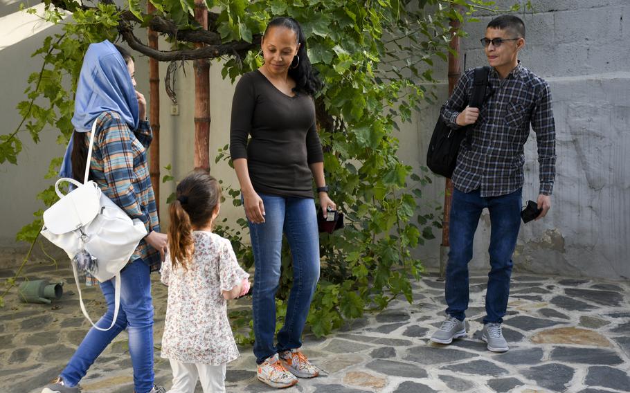 Mohammed Naiem Asadi, his wife Rahima, and their daughter, Zainab, meet with lawyer Kimberley Motley prior to leaving Kabul, Afghanistan, on June 1, 2021. Motley said the family received visas in early May to come to America after months of uncertainty. 