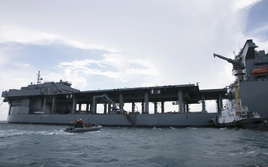 Navy officers, including the commander of Expeditionary Strike Group 7, Rear Adm. Chris Engdahl, head out to tour the USS Miguel Keith at White Beach Naval Facility, Okinawa, Oct. 6, 2021. 