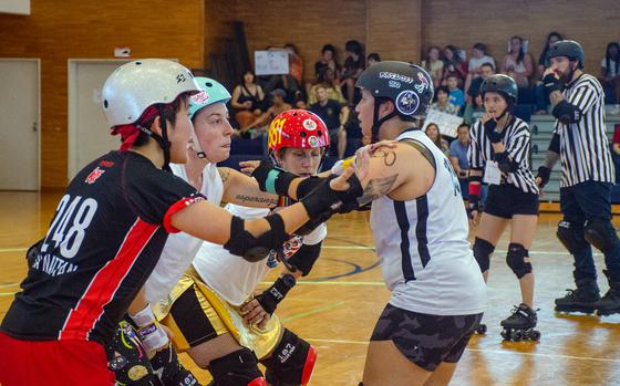 The Vampires and Werewolves roller derby teams compete inside Purdy Gym at Yokosuka Naval Base, Japan, June 17, 2023. 