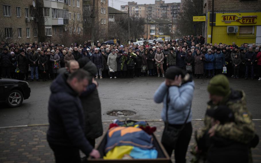 Bucha relatives gather to mourn the body of Oleksiy Zavadskyi, a Ukrainian serviceman who died in combat on Jan. 15 in Bakhmut, during his funeral in Bucha, Ukraine, Thursday, Jan. 19, 2023.