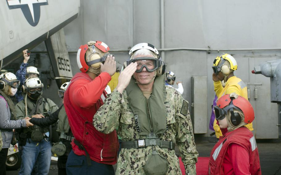 The commander of the U.S. 7th Fleet, Vice Adm. Karl Thomas, salutes before departing the USS Carl Vinson at the conclusion of ANNUALEX in the Philippine Sea, Tuesday, Nov. 30, 2021. 