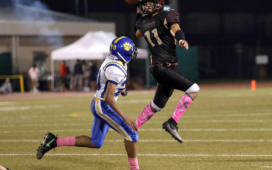 Matthew C. Perry's Nickolas Elizondo tries to unload the ball on the run in front of Yokota's Kamaury Freeman.