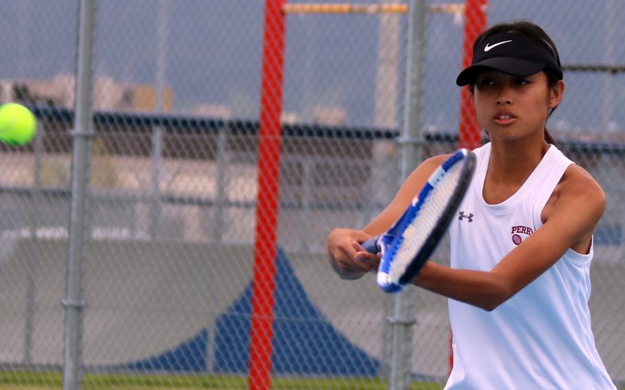 Matthew C. Perry's Aiana Bulan hits a backhand against E.J. King during Friday's DODEA-Japan tennis matches. Bulan won her singles over Kana Fisher 8-2, then teamed with Ivanelis Nieves-Bermudez to beat Fisher and Joanna Hall 8-1 in doubles.