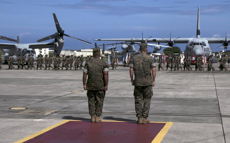 The 1st Marine Aircraft Wing's outgoing commander, Maj. Gen. Brian Cavanaugh, left, and his successor, Maj. Gen. Eric Austin, review the wing's Marines at Marine Corps Air Station Futenma, Okinawa, Friday, Aug. 12, 2022.