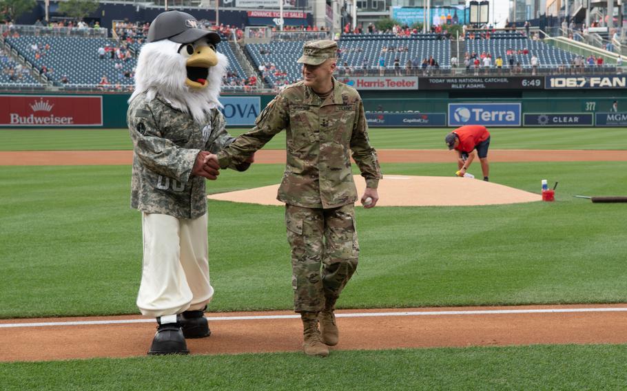Lt. Gen. John B. Morrison Jr. is joined by Nationals mascot Screech after throwing out ceremonial first pitch for U.S. Army Day at Nationals Park in Washington, D.C., on Friday, June 16, 2023. The Nationals hosted the Miami Marlins.