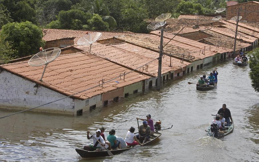 People travel by boat in a flooded street in Trizidela do Vale, state of Maranhao, Brazil, May 9, 2009. The intensity of extreme drought and rainfall has “sharply” increased over the past 20 years, according to a study published Monday, March 13, 2023, in the journal Nature Water.
