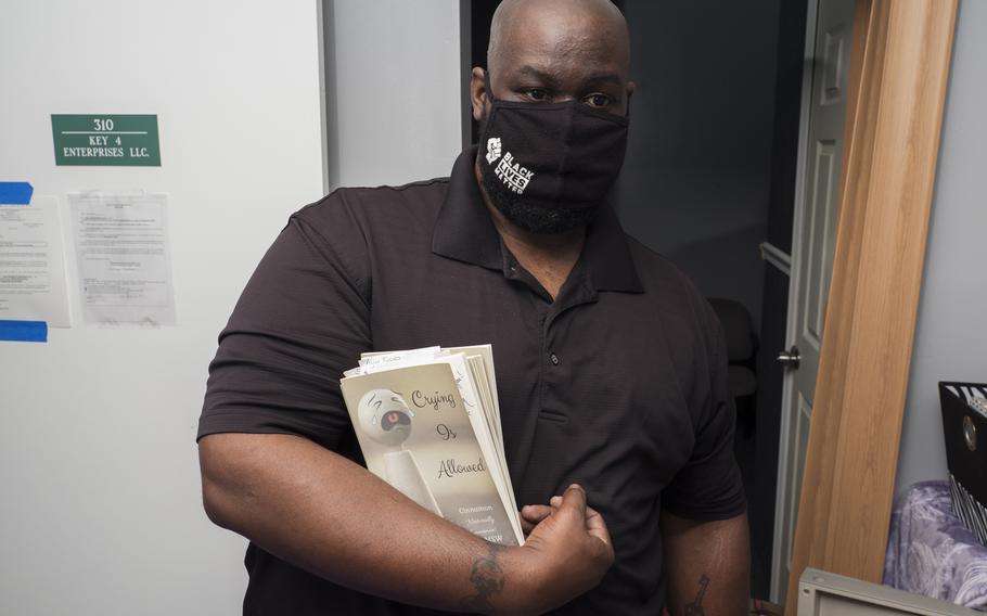 Jeremy Key packs his sister's books on May 28, 2021. Cinnamon Jamila Key was diagnosed with COVID-19 shortly after getting her first dose of a coronavirus vaccine.