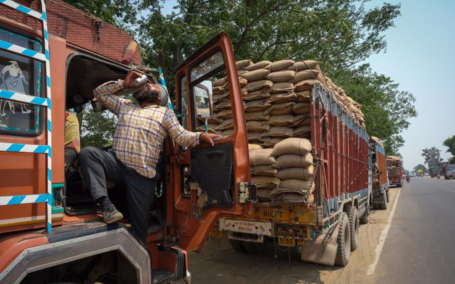 A truck driver loaded with wheat sacks drinks water at the grain market in Khanna district of Punjab, India, on April 30, 2022. MUST CREDIT: Bloomberg photo by T. Narayan