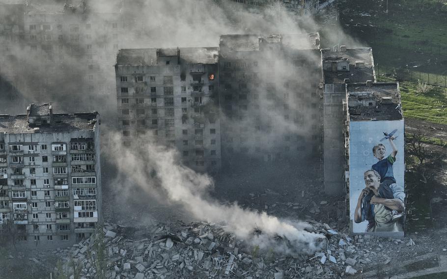 Smoke rises from a building in Bakhmut, the site of the heaviest battles with the Russian troops in the Donetsk region, Ukraine, Wednesday, April 26, 2023. 
