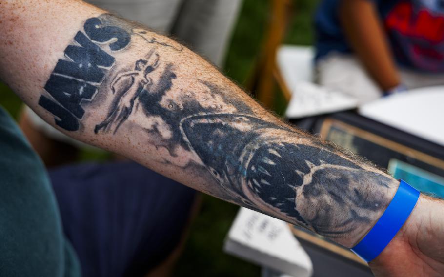 A “Jaws” arm tattoo.