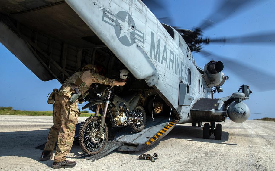 Members of the 1st Marine Aircraft Wing load a CH-53E Super Stallion during an exercise in Ie Shima, Okinawa, March 17, 2021.