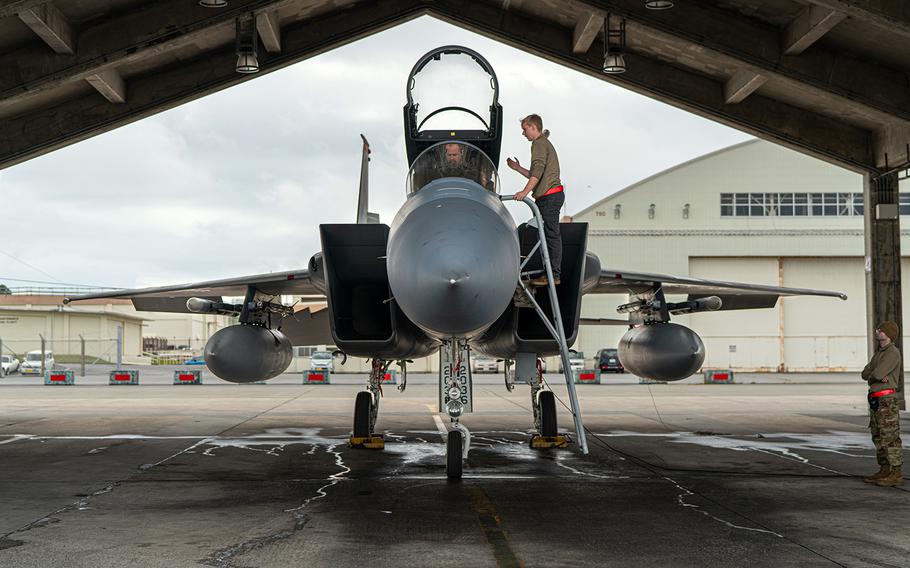 Airman 1st Class Gavin Tullier, a crew chief with the 67th Aircraft Maintenance Unit, finalizes preflight checks with an F-15C Eagle pilot at Kadena Air Base, Okinawa, March 15, 2023.