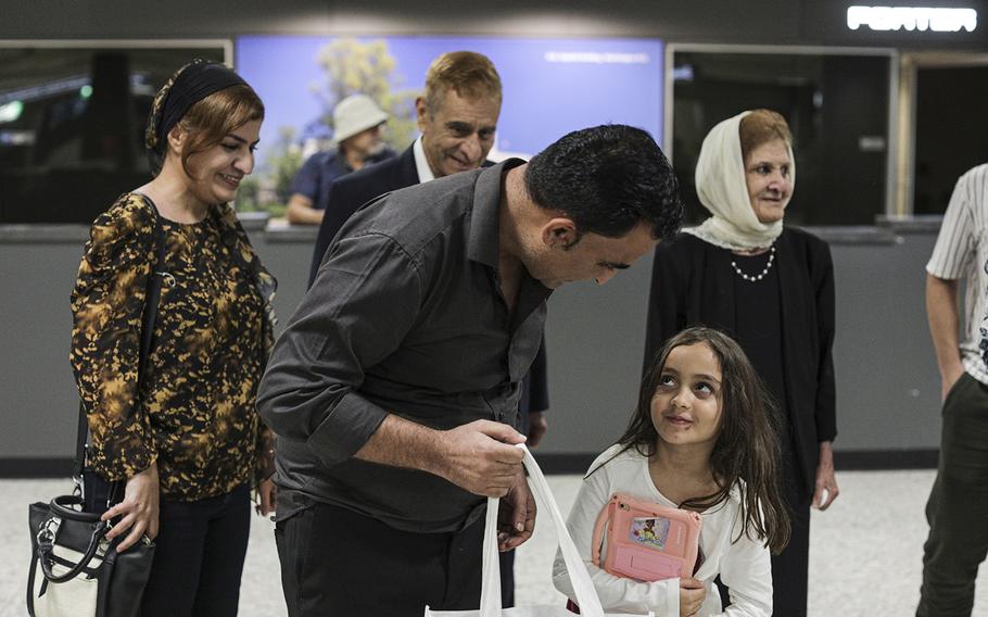 Wali Stanekzai with daughter Mina after arriving at Dulles Airport on Sept. 18, 2022.