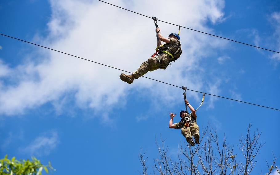Soldiers in the Army’s Best Ranger Competition zip-line across the Chattahoochee River in downtown Columbus, Ga. on Saturday, April 15, 2023. 