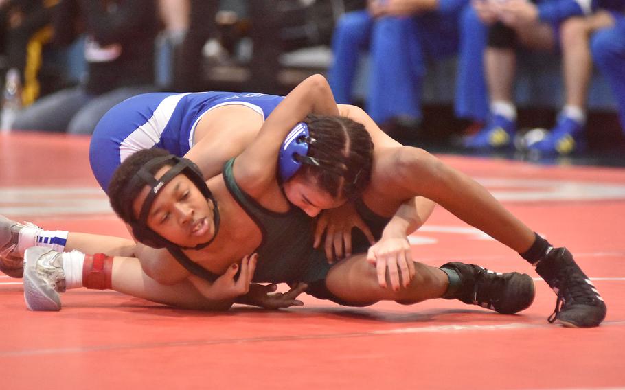 Rota's Quenette Kirkconnell has Naples' Deshawn Bowie in her grasp in a 106-pound match Saturday, Feb. 4, 2023, at the DODEA-Europe Southern Europe regional at Aviano Air Base, Italy. Bowie rallied to win.