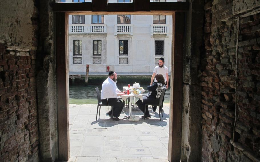 The entrance to Venice's Jewish ghetto is through a small alley off a street of shops and restaurants. This is the view looking out to the street.