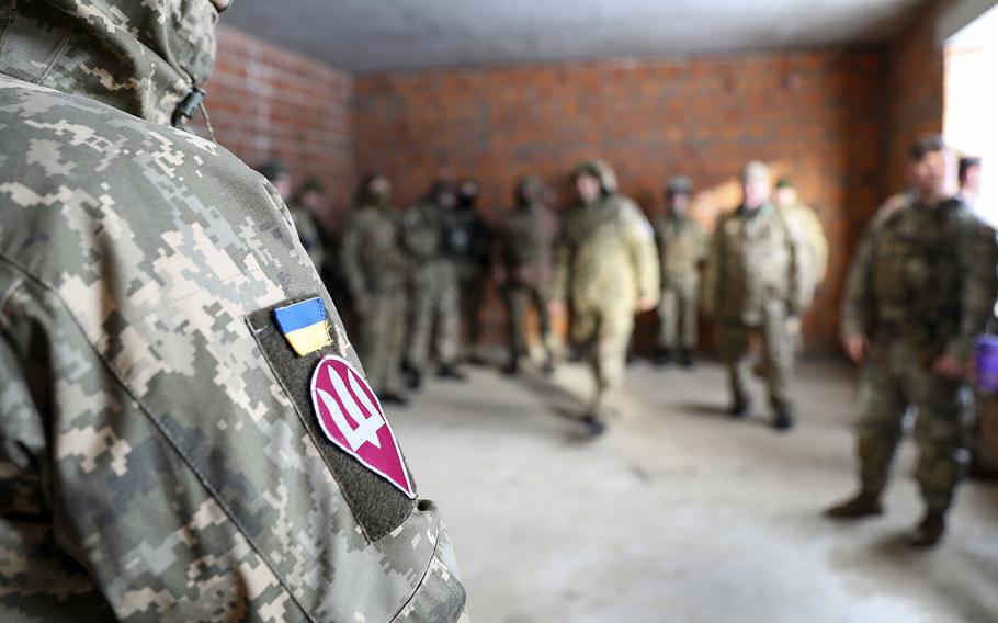 Ukrainian soldiers listen to a training brief at the International Peacekeeping and Security Center at Yavoriv, Ukraine, Feb. 3, 2022. The Florida Army National Guard's 53rd Infantry Brigade Combat Team trained Ukrainians there before the Russian invasion. The training is now taking place in Grafenwoehr, Germany.