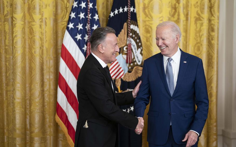 President Joe Biden presents Bruce Springsteen with a National Medal of Arts medal during a ceremony in the East Room at the White House on Tuesday.