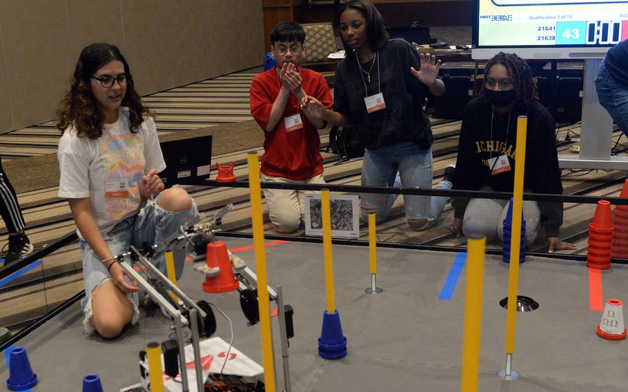 Matthew C. Perry seniors Maddie Medina and Emanuel Paalam, freshman Jordin Knight and junior Sa'nia Moore attempt to get their robot to put a cone through a pole.