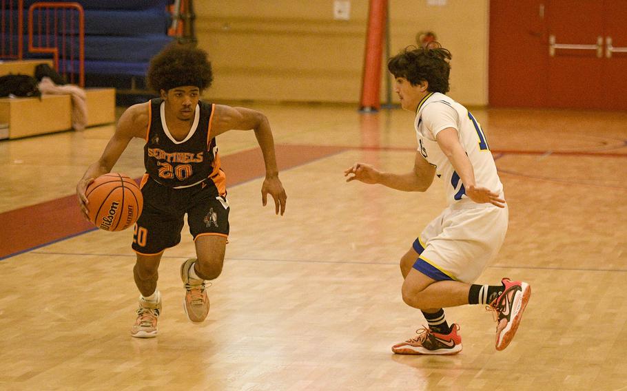 Spangdahlem’s Javian Rivera drives past Sigonella’s Alessandro Montero during a DODEA-Europe Division III basketball semifinal game Feb. 17, 2023, in Baumholder, Germany.