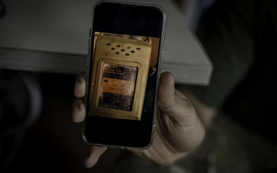 Andrii shows a photo of the Russian radio he found on a dead soldier. 