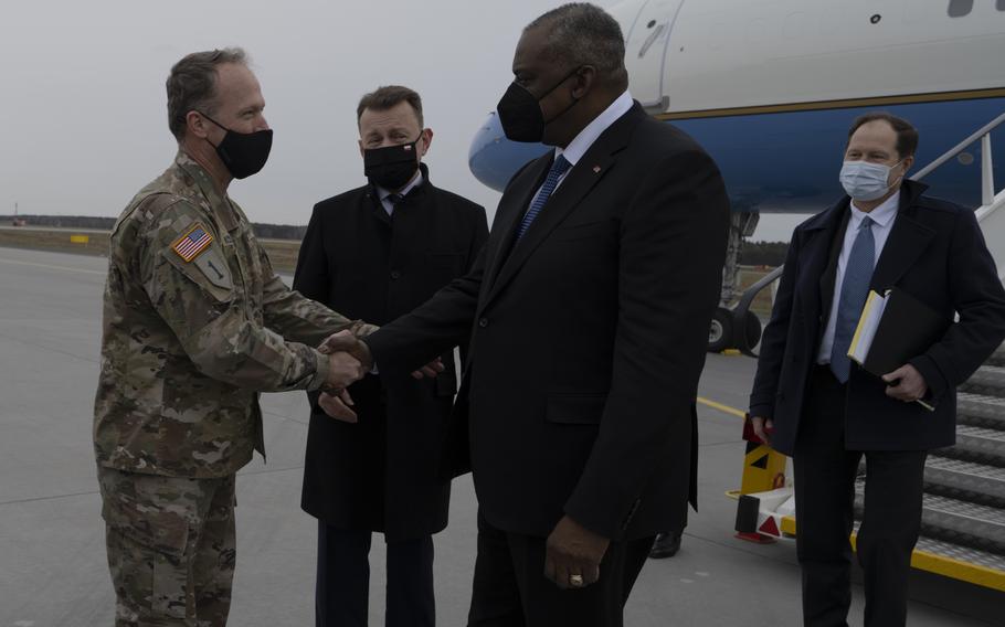 Lt. Gen. John S. Kolasheski, commanding general of V Corps, greets Defense Secretary Lloyd Austin, Polish Defense Minister Mariusz Blaszcak and U.S. Ambassador to Poland Mark Brzezinski upon their arrival to Powidz Air Base, Feb. 18, 2022. 