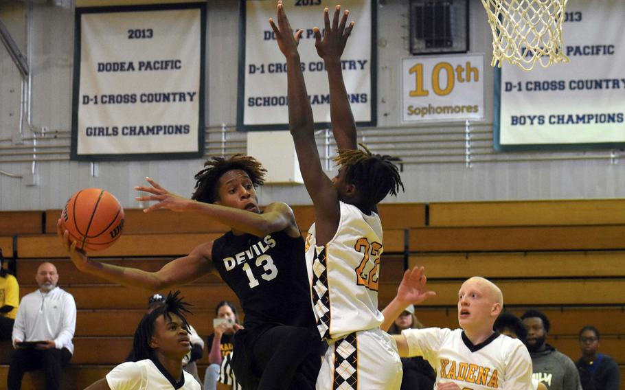 Nile C. Kinnick's Jaelin White looks for room against Kadena's Jayden Allen. The Panthers won 64-62.