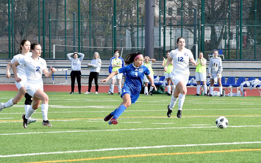 Ramstein's Isabel Fischer, center, leads a chase after the ball during Saturday morning's match against Wiesbaden at Ramstein High School on Ramstein Air Base, Germany. The Warriors' Alaura Stelker, left, and Hannah Buccheit, right, are in pursuit.