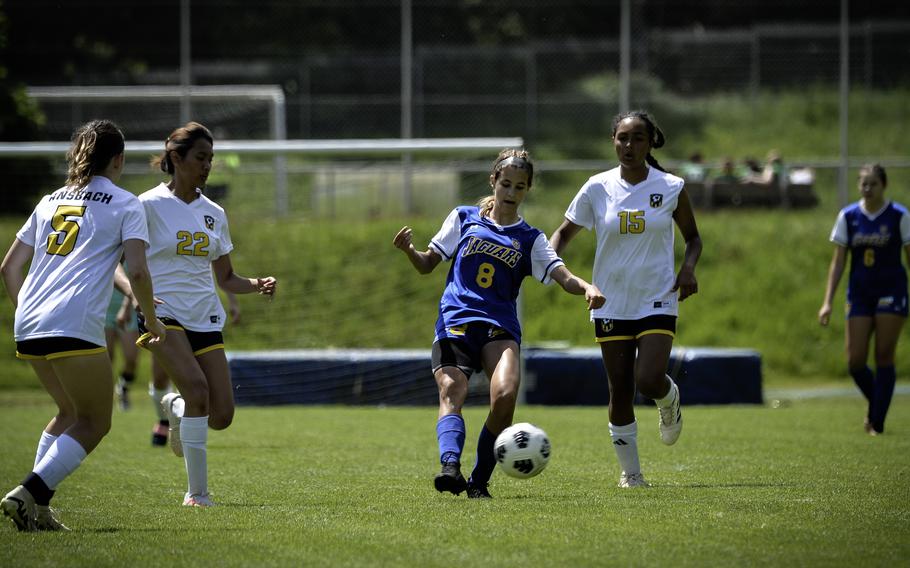 Madison Hoy of Sigonella navigates past Ansbach’s Annika Asbury, from left, Kylah Tuazon, and Victoria Ortiz, before passing the ball to a teammate during the 2024 DODEA European Soccer Division III Championships in Landstuhl, Germany, on May 20, 2024.
