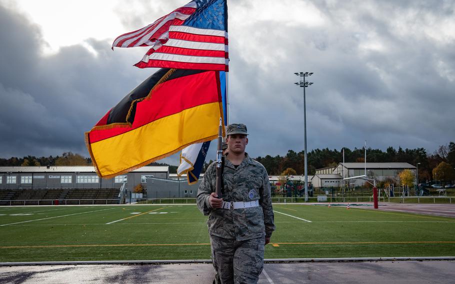Air Force JROTC cadet Dorian Braun of Ramstein High School marches with a joint color guard at Kaiserslautern High School in Vogelweh, Germany, Friday, Nov. 10, 2023. 