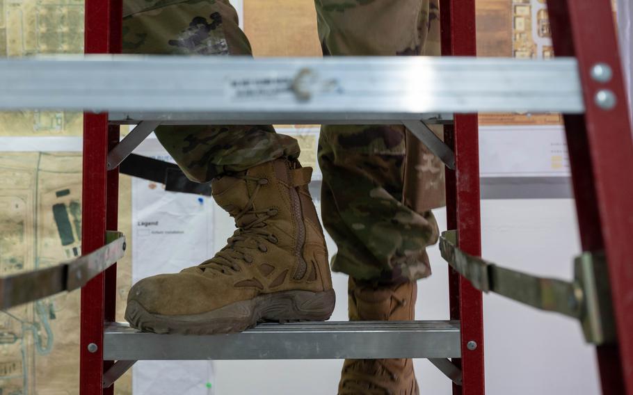 Military boots climbing a ladder.
