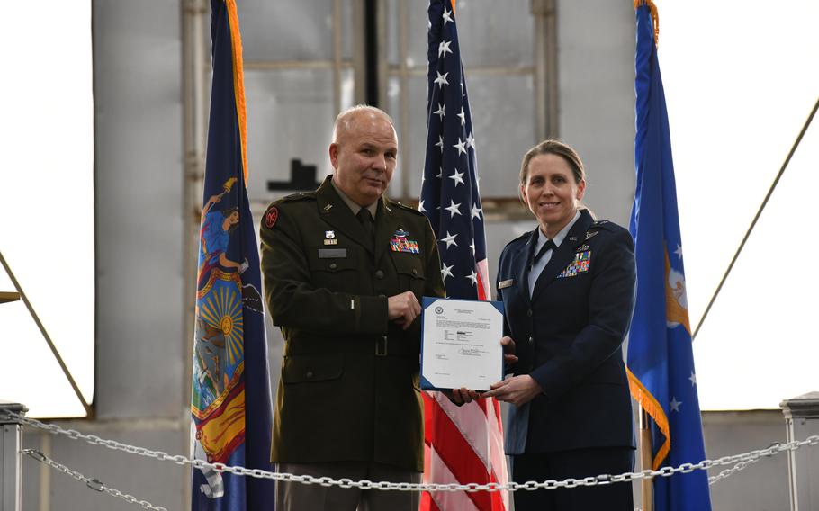 Maj. Gen. Ray Shields, the adjutant general of New York, and Maj. Gen. Denise Donnell, the commander of the New York Air National Guard, display her promotion orders during her promotion ceremony on Jan. 6, 2023 at Stratton Air National Guard Base in Scotia, New York.