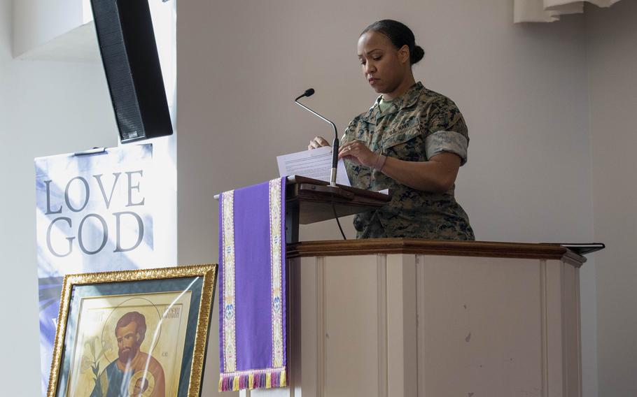 Petitfrere prepares to deliver her sermon at the United States Marine Corps Memorial Chapel in Quantico. The image of a saint was left over from a Catholic service earlier in the morning.