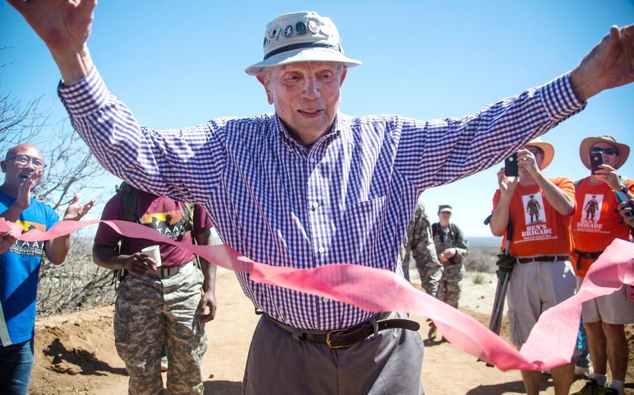 Bataan Death March survivor, Col. Ben Skardon, 97, from Clemson, S.C., crosses the finish line for the eighth time during the Bataan Memorial Death March at White Sands Missile Range, N.M., March 22, 2015. Skardon died Monday at age 104 at his home in Clemson.