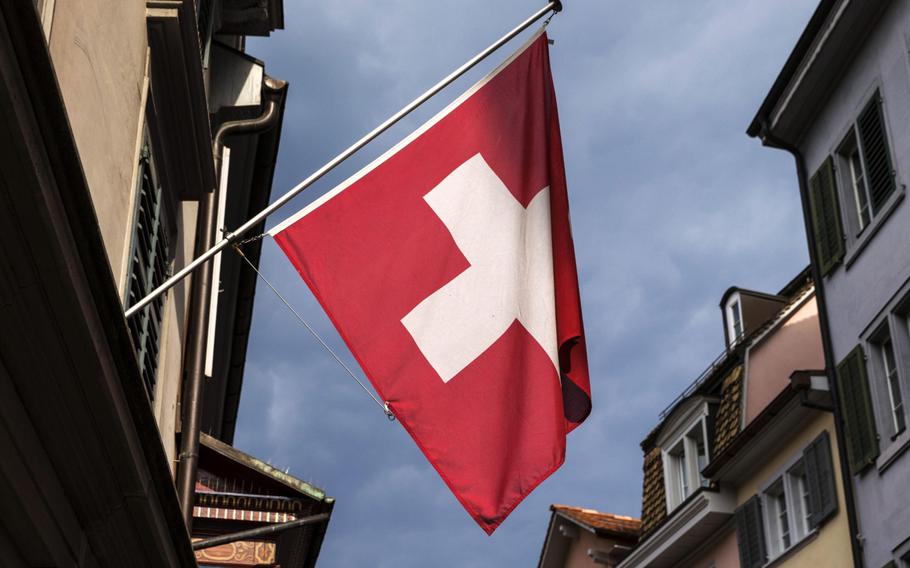 A Swiss national flag flies in downtown Zurich on Aug. 6, 2015. 