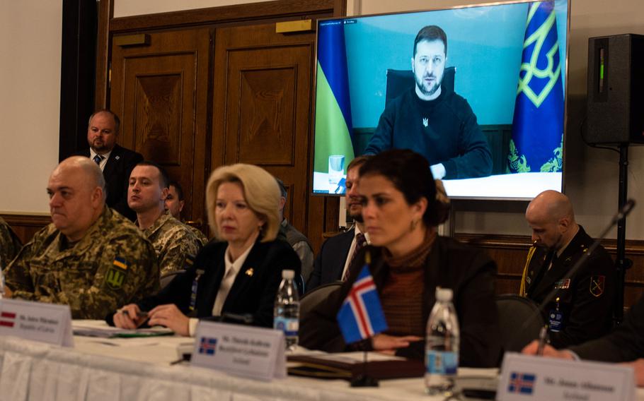 International defense officials listen to a video message from Ukraine President Volodymyr Zelenskyy during the Ukraine Defense Contact Group meeting on Jan. 20, 2023, at Ramstein Air Base, Germany. Zelenskyy expressed thanks for continued support but said new defense commitment will be needed for Ukraine to be able to bolster its defenses against continued Russian aggression and ahead of a feared spring offensive.
