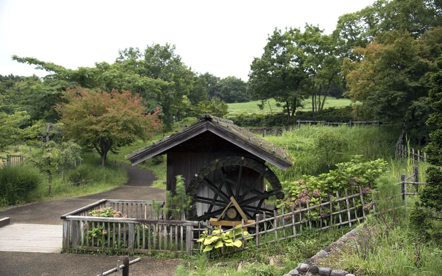 A water-powered mill stands in the Komorebi Village area of Showa Memorial Park in Tachikawa, Tokyo, Tuesday, July 27, 2021.