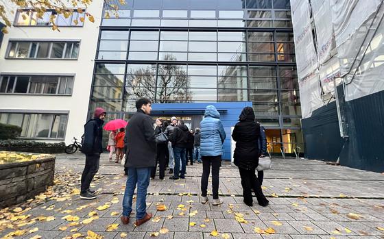 People stand in front of Kaiserslautern District Court on Nov. 30, 2022.