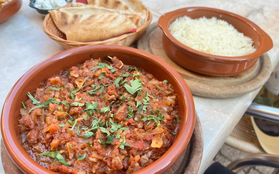 The Bacan roasted eggplant at Civat Middle Eastern Kitchen comes with a rich tomato garlic and herb sauce, served with a side of rice and flatbread.