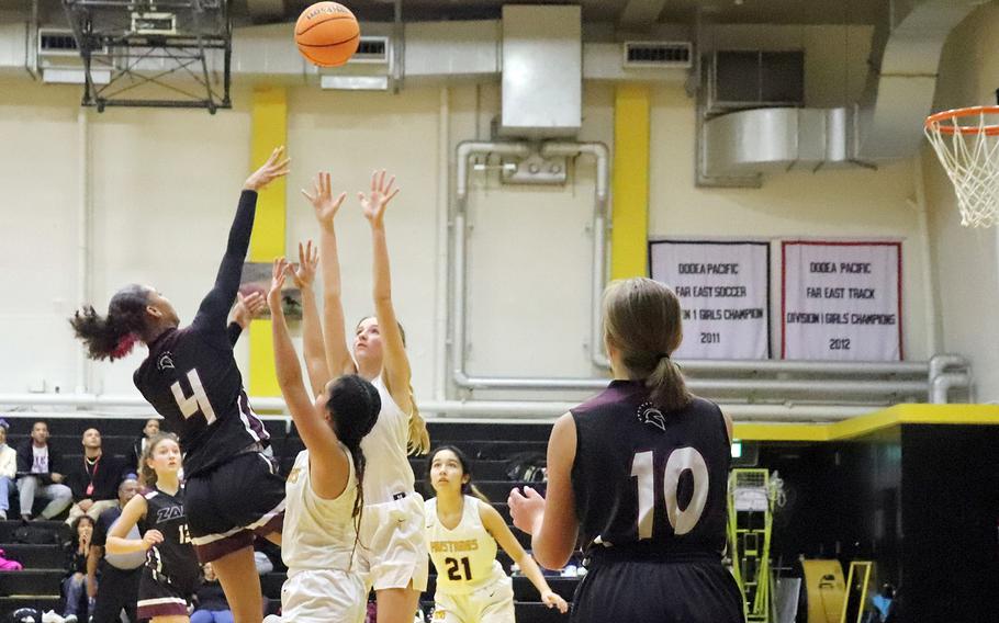 Zama's Naviah Blizzard shoots over American School In Japan defenders Anna Haneda and Amelia Fallon during Wednesday's Kanto Plain girls basketball game. The Mustangs won 38-32.