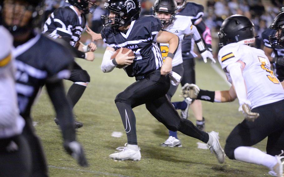 Zama quarterback Will Schmiedel scampers through traffic for a seven-yard gain.