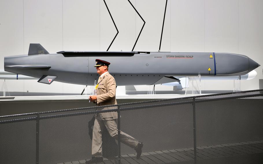 A member of the military walks past a MBDA Storm Shadow/Scalp missile at the Farnborough Airshow, south west of London, on July 17, 2018. 