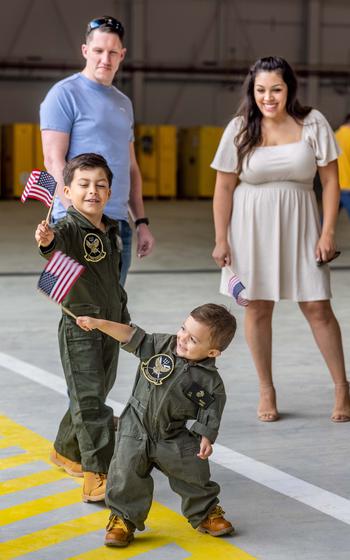 The family of a U.S. Marine wait to reunite with their service member after returning from deployment with the 26th Marine Expeditionary Unit, Marine Corps Air Station New River, N.C., Saturday, March 16, 2024.