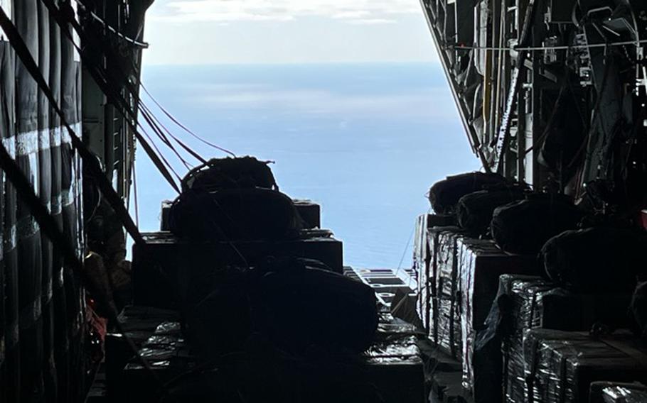 A U.S. Air Force loadmaster prepares for release of humanitarian aid pallets of packaged food and water supplies in several waves at multiple locations outside of population centers throughout Gaza, March 10, 2024. 