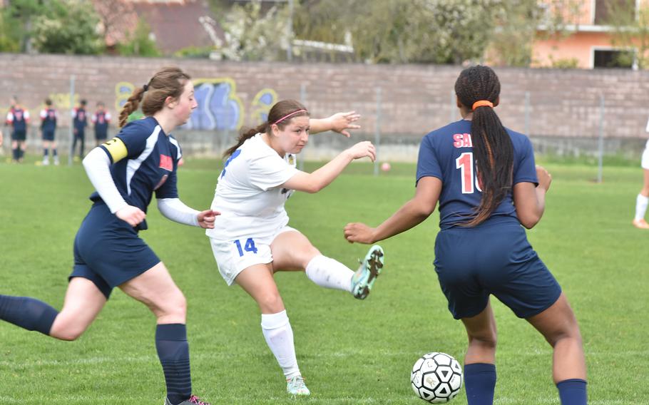 Sigonella's Isabelle Balleza shoots on goal while Aviano's Mayci Salmon, left, and Amirah Johnson attempt to stop her Saturday, April 15, 2023, in the Jaguars' 4-1 victory over the Saints.