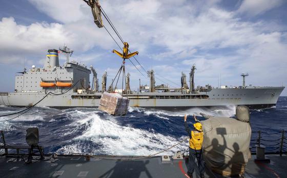 230111-N-SN516-1137 PHILIPPINE SEA (Jan. 11, 2023) U.S. Navy Boatswain’s Mate 3rd Class Keaton Lester, from Wichita Falls, Texas, signals to the fleet replenishment oiler USNS Guadalupe (T-AO 200) during a replenishment-at-sea (RAS) aboard the Arleigh Burke-class guided-missile destroyer USS Decatur (DDG 73). Decatur, part of the Nimitz Carrier Strike Group, is in U.S. 7th Fleet conducting routine operations. 7th Fleet is the U.S. Navy’s largest forward-deployed numbered fleet, and routinely interacts and operates with Allies and partners in preserving a free and open Indo-Pacific region. (U.S. Navy photo by Mass Communication Specialist 2nd Class David Negron)